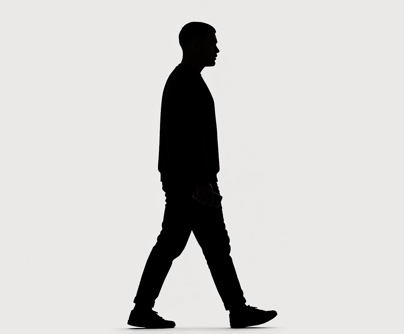 A man walking, in silhouette.
